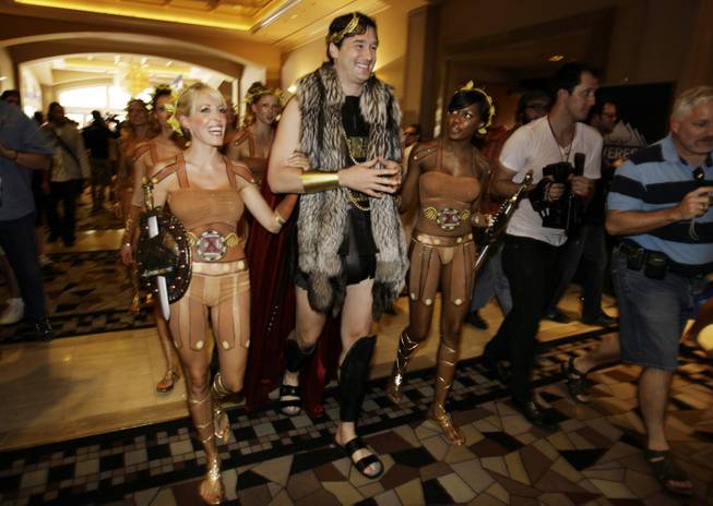 Professional player Phil Hellmuth walks into a throng of fans at the Rio Hotel and Casino in Las Vegas on the third start day of the World Series of Poker on Sunday, July 5, 2009.