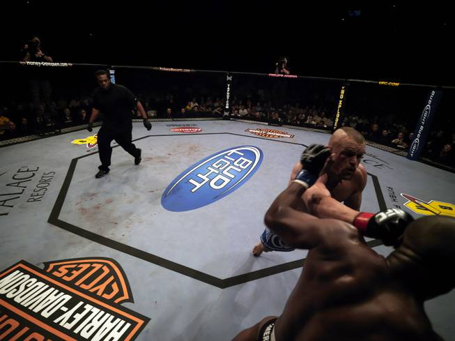 UFC referee Herb Dean takes a look at the action between Chuck Liddell and Rashad Evans at UFC 88 last September in Atlanta. Evans won the fight with a brutal knockout of "The Iceman."