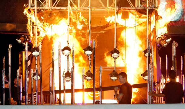 Linkin Park frontman Chester Bennington watches the equipment case with magician Steve Wyrick inside go up in flames outside Planet Hollywood.