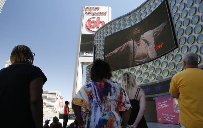 People watch live television news coverage of the Michael Jackson memorial outside Planet Hollywood on Tuesday. 
