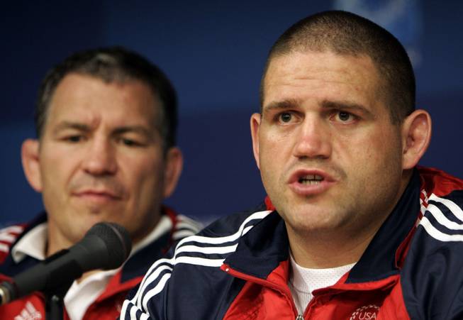 USA wrestling coach Steve Fraser, left, listens as American Greco-Roman wrestler Rulon Gardner talks to the media before the start of the Athens Olympics in Athens, Monday Aug. 9, 2004. Fraser has been happy to see some of his former wrestlers in the UFC, such as Randy Couture and Dan Henderson. However he hopes it won't start a trend of his athletes leaving the sport.

