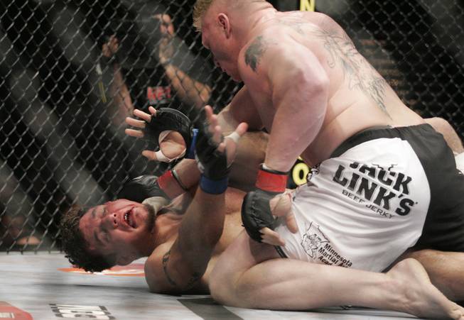 Brock Lesnar mashes his thumb into Frank Mir's throat during their heavyweight title fight at UFC 100 on Saturday, July 11, 2009. Lesnar won via stoppage in the second round.