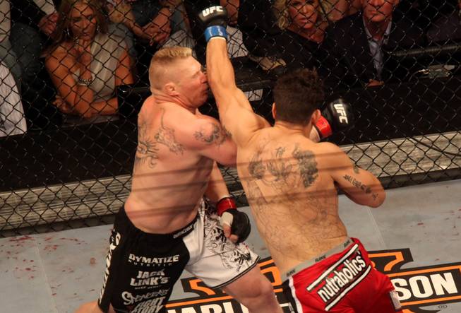 Frank Mir skims Brock Lessner with a left punch during their heavyweight title fight at UFC 100 at Mandalay Bay Saturday night. Lesnar won with stoppage in the second round.