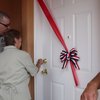 Victor Valdera and his mother, Herna, open the front door to their new home. Three homes were dedicated Friday by Habitat for Humanity and its sponsors to families.