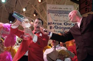 Anthony Alba, an executive mixologist representing the Nevada Chapter of the United States Bartenders Guild, makes an oversize gin martini during a party to celebrate the 70th birthday of Las Vegas Mayor Oscar Goodman. At right is KLUC's Chet Buchanan.