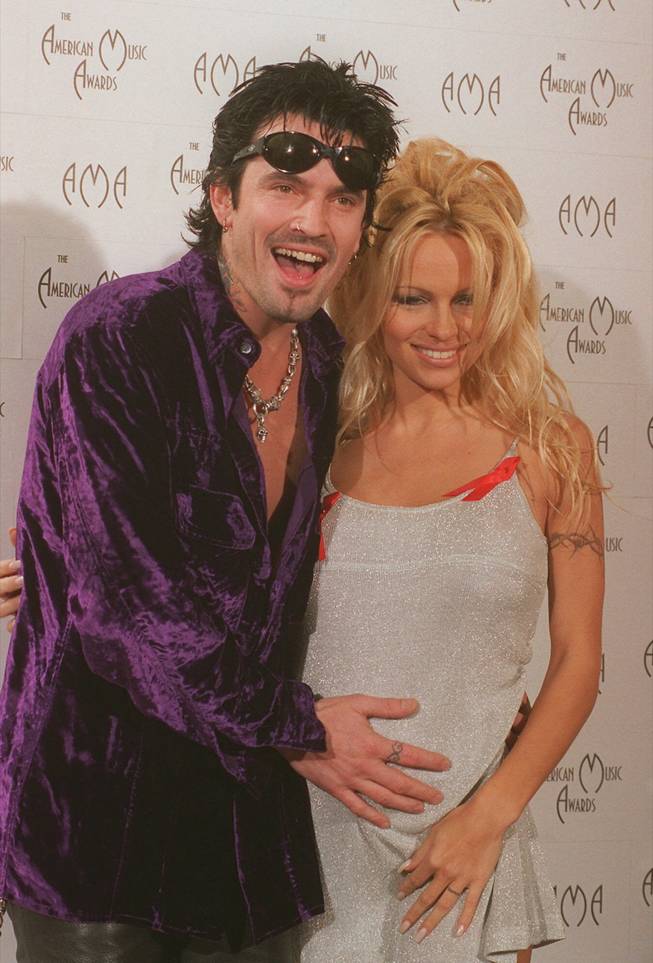 In this photo from Jan. 19, 1996, rock singer Tommy Lee places his hand near the stomach of his then-pregnant wife Pamela Lee during the 23rd annual American Music Awards at the Shrine Auditorium in Los Angeles. The couple has had an on-again-off-again relationship over the years that seems to be on again.