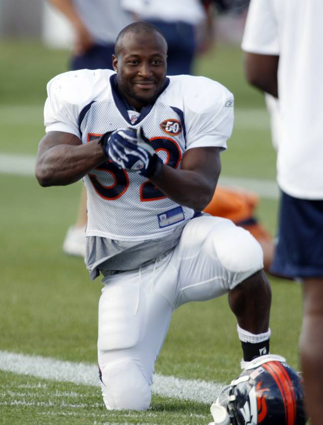 Denver Broncos running back LaMont Jordan jokes with teammates before drills during NFL football training camp in Englewood, Colo., on Wednesday, Aug. 5.