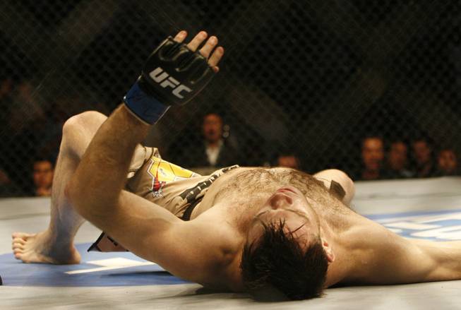 Fans of mixed martial arts and the UFC gather at the Wachovia Center on Saturday evening August 8, 2009 for a night of fighting. Light heavyweight Forrest Griffin lays on the mat after being knocked out by UFC Champion Anderson Silva.