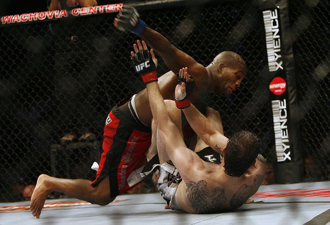 Fans of mixed martial arts and the UFC, Ultimate Fighting Championship gather at the Wachovia Center on Saturday evening August 8, 2009 for a night of fighting. Battle between Welterweights John Howard (black guy) and Tamden Leites. Winner Howard.