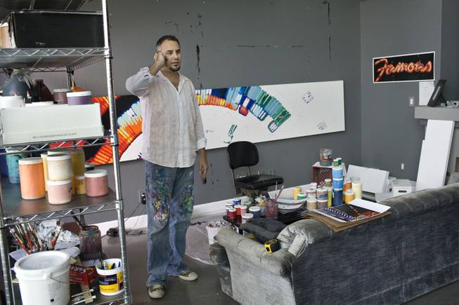 Artist Jerry Misko takes a call at his home studio while finishing a painting for his new show, "Jerry F**kin Misko," in Las Vegas on Wednesday Aug. 12, 2009. 