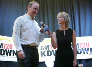 Former North Las Vegas mayor Mike Montandon takes the mic from radio personality Heidi Harris during a town hall meeting at Stoney's Rockin' Country sponsored by talk radio station KDWN Friday, Aug. 14, 2009. 