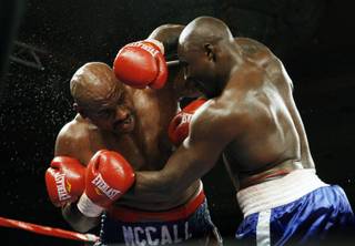 Heavyweight boxers Oliver McCall, left, and Franklin Lawrence battle at the Orleans on Friday. McCall won the 10-round fight by unanimous decision.
