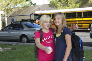 Jaden Wood greets her friend, Emma Jeppsen, right, as they arrive Monday for their first day of sixth grade at Elton Garrett Middle School in Boulder City.
