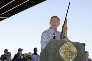 Senate Majority Leader Harry Reid (D-NV) holds up his childhood .22 caliber rifle during the dedication of the Clark County Shooting Park at the north end of Decatur Boulevard Tuesday. 