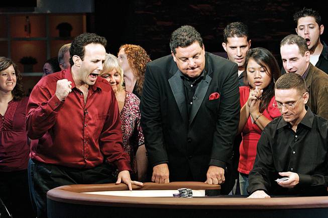 
Adam Ehrlich, 33, of Philadelphia, left, celebrates a hand during NBC's taping Sunday of "Face the Ace," hosted by Steve Schirripa, center, at South Point.
