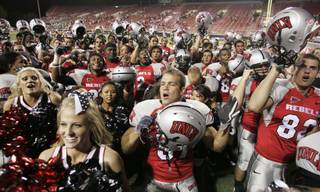 UNLV cheerleaders and players sing the UNLV fight song after defeating Sacramento State 38-3 Saturday at Sam Boyd Stadium.