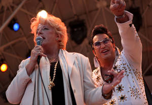 Carolyn Goodman talks to the crowd with Elvis tribute artist Jesse Garon by her side as her and her husband of 47 years, Las Vegas Mayor Oscar B. Goodman, renewed their wedding vows Wednesday at the Fremont Street Experience in celebration of 9/9/09.