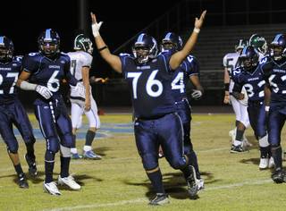 Pioneers defensive lineman Nicolas Rogers (76) celebrates after making an interception in the second half against Green Valley at Canyon Springs High School on Friday night.
