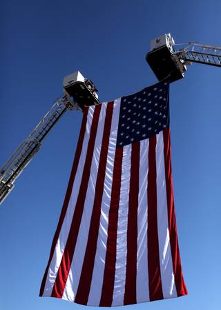 An flag is raised by two cranes during a ceremony Friday at the Clark County Government Center Amphitheater to commemorate the eighth anniversary of the Sept. 11, 2001, terrorist attacks in New York, Washington, D.C., and Pennsylvania.