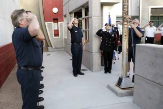 A flag that once flew over the World Trade Center is hoisted to half-staff Friday over a piece of steel from the World Trade Center as members of Las Vegas Fire & Rescue Station No. 5 joined in a remembrance of those who lost their lives in the terrorist attacks on Sept. 11, 2001.