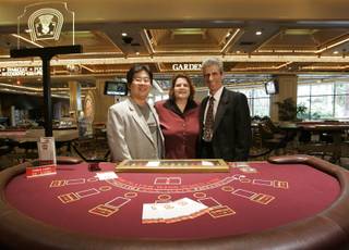 Sung Chang, left, and Stephanie and George Boutsifakos invented a new table game called Two Cards High that is beginning a trial period at the Flamingo.  