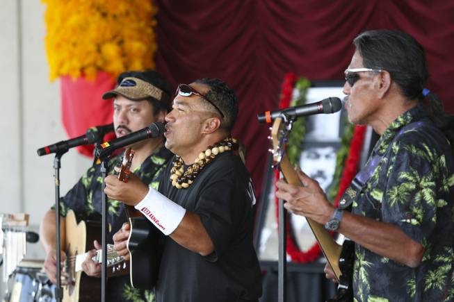 Jonathan Hoomanawanui, center, sings and plays the ukulele while performing with the Hula Halau O Kaumualii group Saturday at the Pacific Islands Festival at the Henderson Events Plaza.