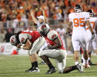 Malo Taumua (left) and Preston Brooks of UNLV drop after Oregon State kicked in the go-ahead field goal Saturday night at Sam Boyd Stadium. Oregon St. won the game 23-21.