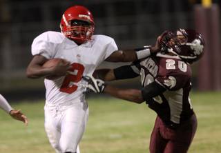 Tim Hasson of Cimarron-Memorial High, right, tries to bring down Taylor Wooten of Arbor View during a game last fall. Hasson, who finished 106 tackles in 2009, has impressed coaches during practices for Saturday's 39th Annual Lions Club all-star game. Hasson will walk-on at UNLV.