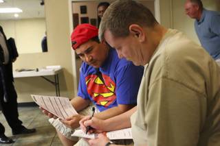 Partners for 23 years, Christopher Espinoza and Joseph Munoz, right, fill out forms for their domestic partnership during a town hall meeting Monday at the Gay and Lesbian Community Center in Las Vegas.
