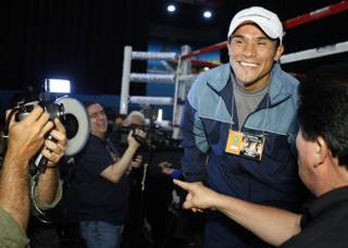 Juan Manuel Marquez smiles as he answers questions from media members inside the MGM Grand Garden Arena Tuesday. Marquez is set to face Floyd Mayweather Jr. this Saturday.