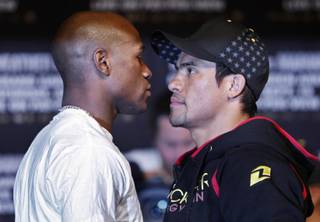 Floyd Mayweather Jr. stares down Juan Manuel Marquez during a press conference at the MGM Grand hotel Wednesday.