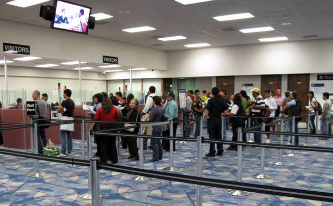 Travelers from an international flight wait in line at the passport check area at McCarran International Airport's Terminal 2 on Wednesday, April 23, 2010.