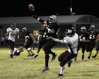 A Panthers linebacker deflects a pass intended for Spartans running back Zach Barbara late in the fourth quarter at Palo Verde High School on Thursday night.