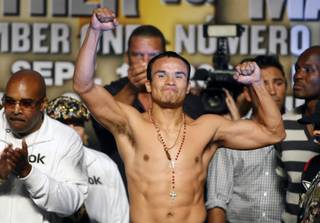 Juan Manuel Marquez gestures towards fans during Friday's official weigh-in at the MGM Grand Garden Arena.