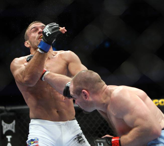 Vladimir Matyushenko (red) hits Igor Pokrajac (blue) in a fight at UFC 103 at American Airlines Center in Dallas tonight.