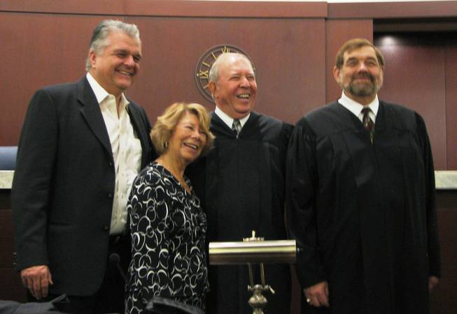 New Searchlight Justice of the Peace Stan Colton, center, celebrates his investiture Sept. 21 with his wife, Suki, County Commissioner Steve Sisolak, left, and Supreme Court Justice Michael Cherry, who swore him in.