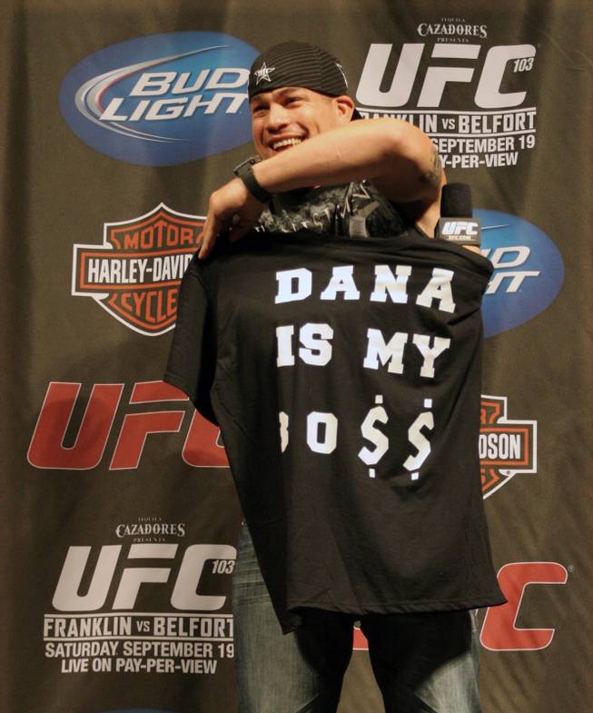 Former UFC light heavyweight champ Tito Ortiz shows off the speciality T-shirt a fan made for him at the UFC 103 Fight Club Q&A session at UFC 103 in Dallas on Friday, Sept. 18, 2009. The slogan of "Dana is my Bo$$," is a play on b-words from the original shirt Ortiz wore when he was at war with UFC President Dana White.