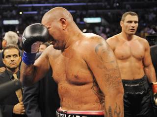 Chris Arreola, of Riverside, Calif., left, weeps after losing by TKO in the 10th round of his bout against World Boxing Council heavyweight champion Vitali Klitschko, right, in their WBC heavyweight title boxing match Saturday, Sept. 26, 2009, in Los Angeles.
