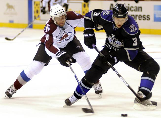 L.A. Kings defenseman Jack Johnson, right, protects the puck from Colorado Avalanche winger Wojtek Wolski during the first period of Frozen Fury XII at MGM Grand Garden Arena on Saturday, Sept. 26, 2009.