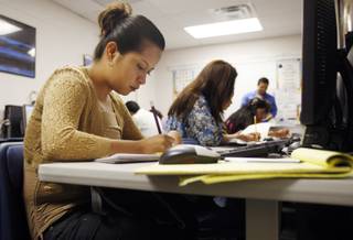 Eva Leticia, 23, works on math problems during a free class Tuesday, Sept. 22, 2009. A school district program with private foundation money uses Mexican government-supplied materials to teach functionally illiterate parents to read and write in Spanish.