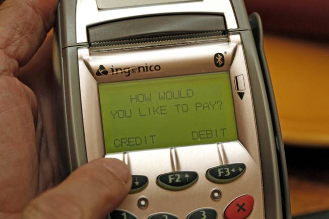 Card security: A pay-at-the-table device is shown at Ricardo's restaurant on Sept. 23. The devices have the potential to reduce fraud as credit cards never leave the customer. 