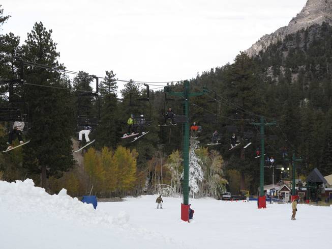 Snowboarders and skiers ride a packed ski lift  to the top a beginner slope at the Las Vegas Ski and Snowboard Resort near Mount Charleston. The resort opened at noon on Wednesday, making it the second ski area in the lower 48 states to open this year.