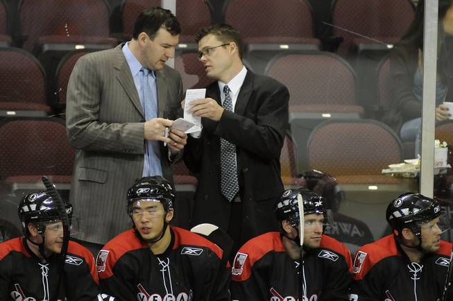 Las Vegas head coach Ryan Mougenel (right) talks with Wranglers Director of Player of Director Development Keith Primeau on the bench during a preseason game against the Ontario Reign on Oct. 8.