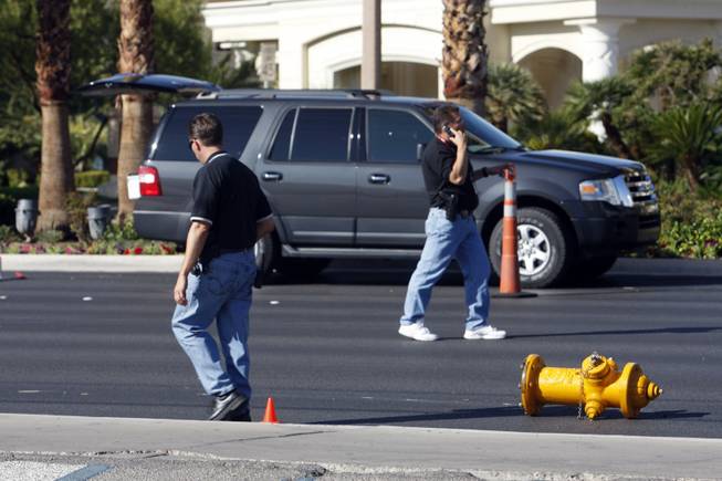 Investigators walk by a fire hydrant after a auto-pedestrian accident involving a 9-year-old boy on Las Vegas Boulevard South near Mandalay Bay on Thursday, Oct. 8, 2009. 