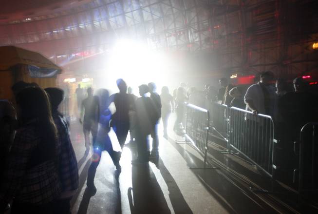 Guests walk through fog and strobe lights in the Fright ...