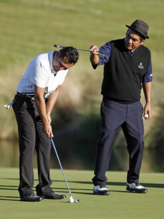 Comedian George Lopez, right, messes with Oscar De La Hoya as he tries to putt on the 18th green during the pro-am portion of the 2009 Justin Timberlake Shriners Hospitals for Children Open golf tournament Wednesday, Oct. 14.
