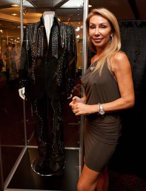 Linda Thompson, Elvis' former girlfriend, with a suit she had designed by Susie Creamcheese for Elvis in 1974 on display at King's Ransom Museum's Elvis Presley exhibit at the Imperial Palace. 