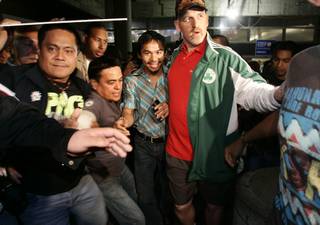 Filipino boxer Manny Pacquiao is greeted by fans as he arrives at Los Angeles International Airport Saturday, Oct. 24.