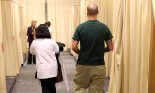 Gabriel Bustamantez heads back to the dressing rooms to be fitted for his new room service uniform Wednesday at the CityCenter Uniform Distribution Center in Las Vegas. CityCenter properties begin opening December 1.