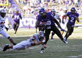 TCU wide receiver Antoine Hicks (13) breaks the tackle-attempt by UNLV cornerback Alex De Giacomo on the way to a touchdown in the first half against UNLV on Saturday, Oct. 31, 2009, in Fort Worth, Texas. 